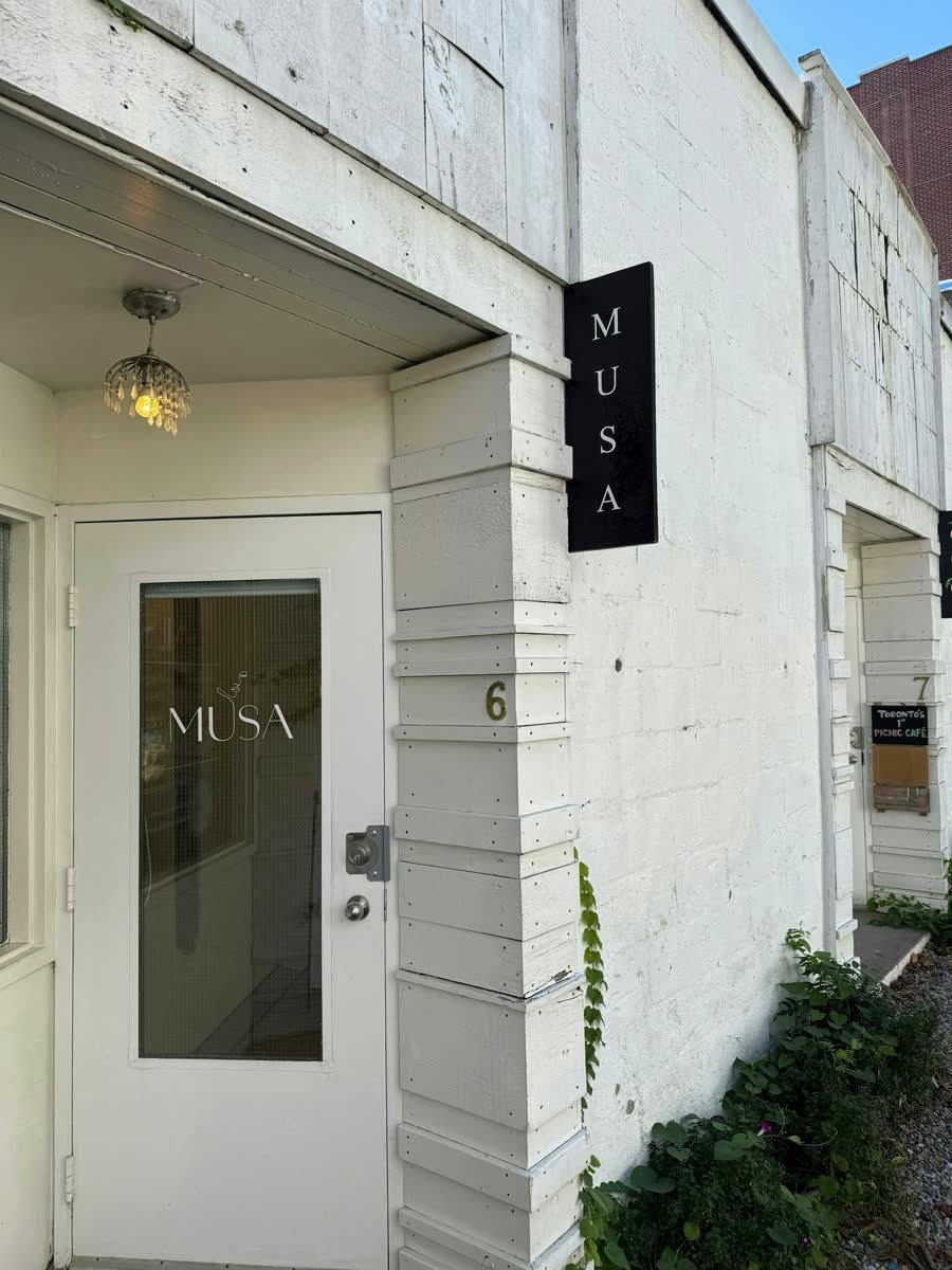Blade sign and window vinyl installed on a medical clinic storefront