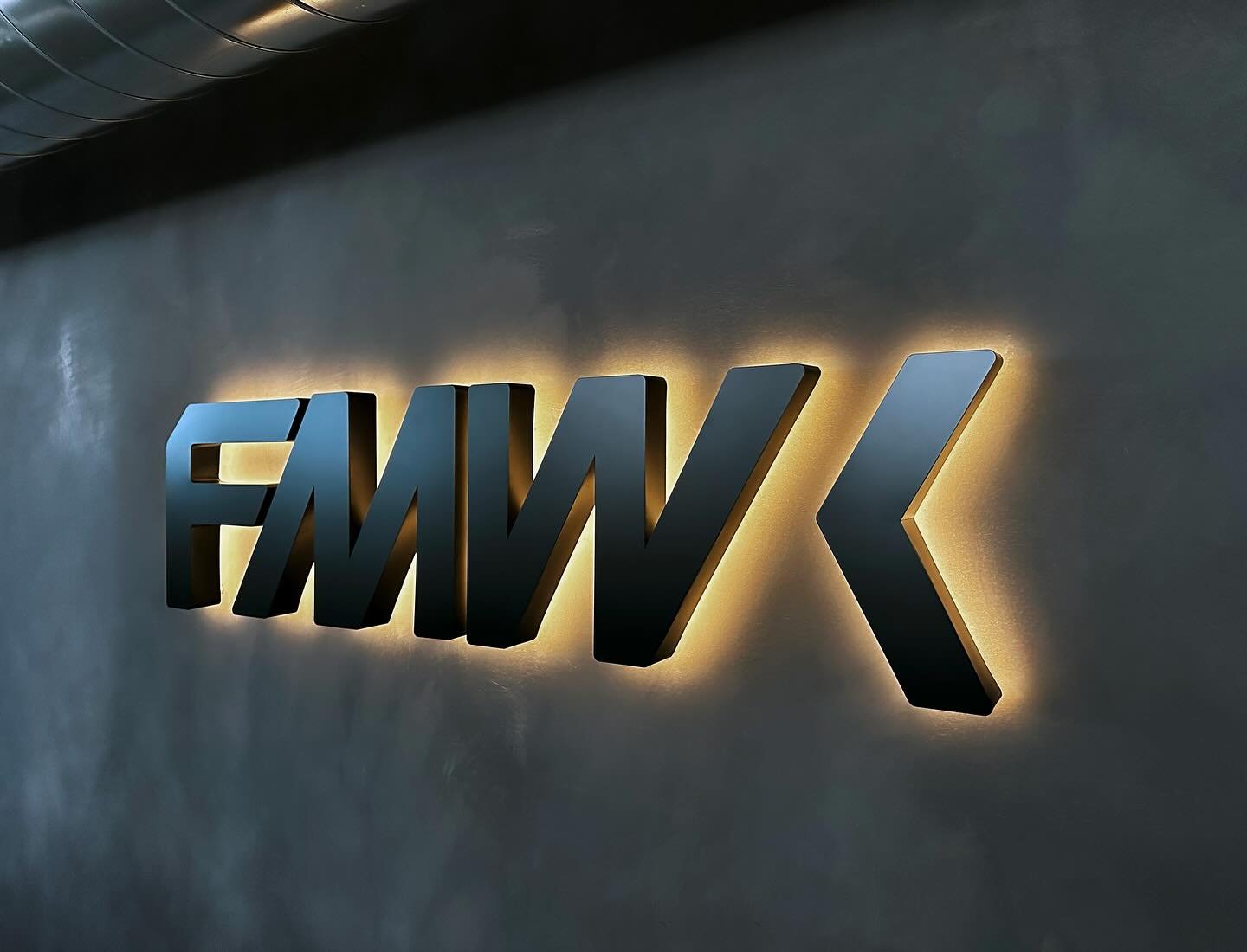 Halo-lit fabricated letters on a refinished exterior aluminum sign panel