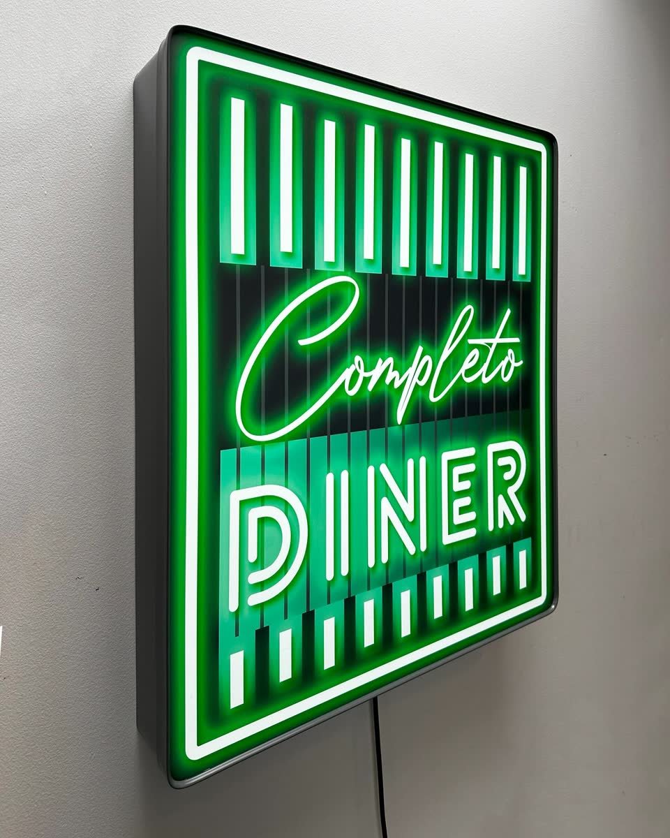 Painted illuminated light box sign above a restaurant entrance