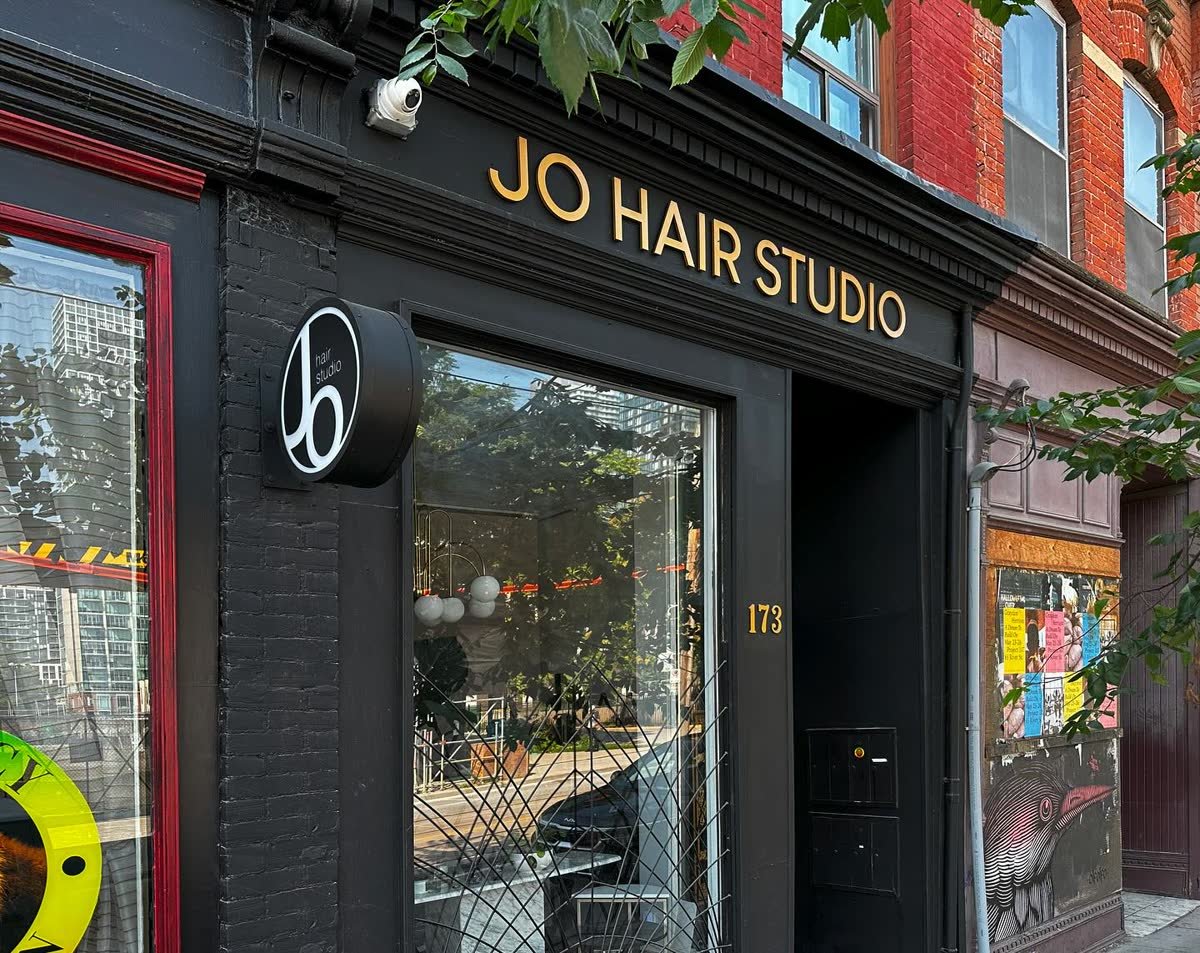 Illuminated blade sign with thick cut acrylic letters at a hair studio