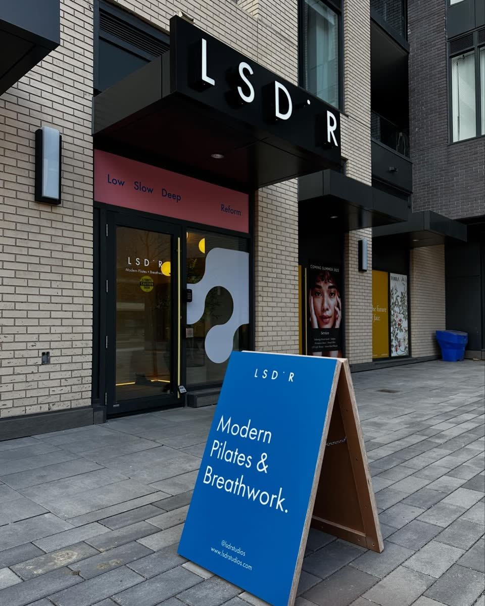 A-frame sidewalk sign with full colour print on a city sidewalk