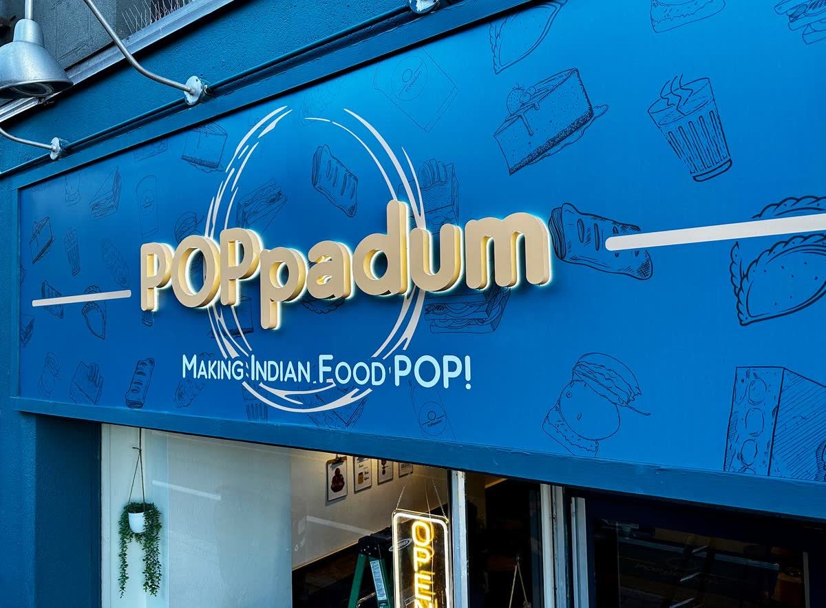 Halo-lit dimensional letters on a blue illustrated restaurant fascia