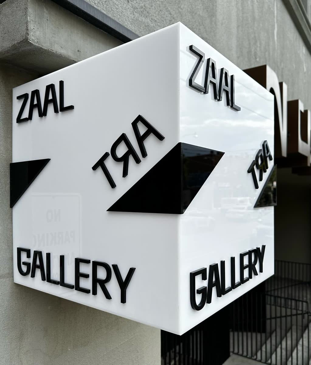 White illuminated acrylic box sign with black laser cut letters