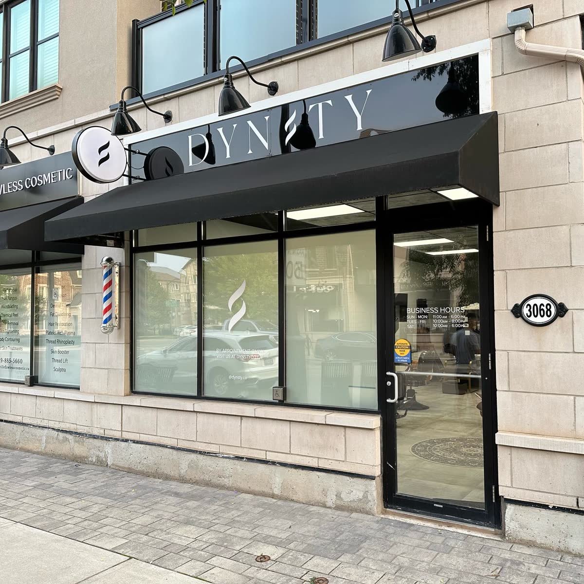 Storefront with white dimensional letters above a black awning